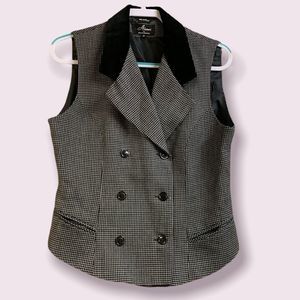 black and white vest with black collar and six buttons on the front size 12.